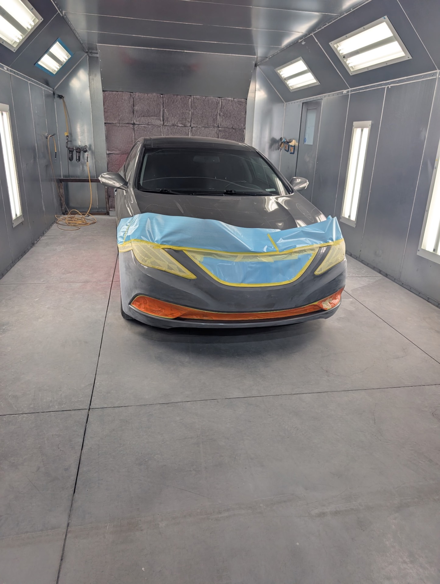 Sedan front end masked and ready for refinishing